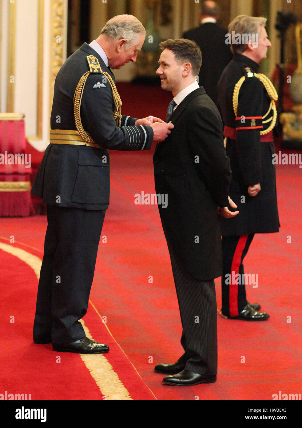 Classical countertenor Iestyn Davies is made an MBE by the Prince of Wales during an Investiture ceremony at Buckingham Palace, London. Stock Photo