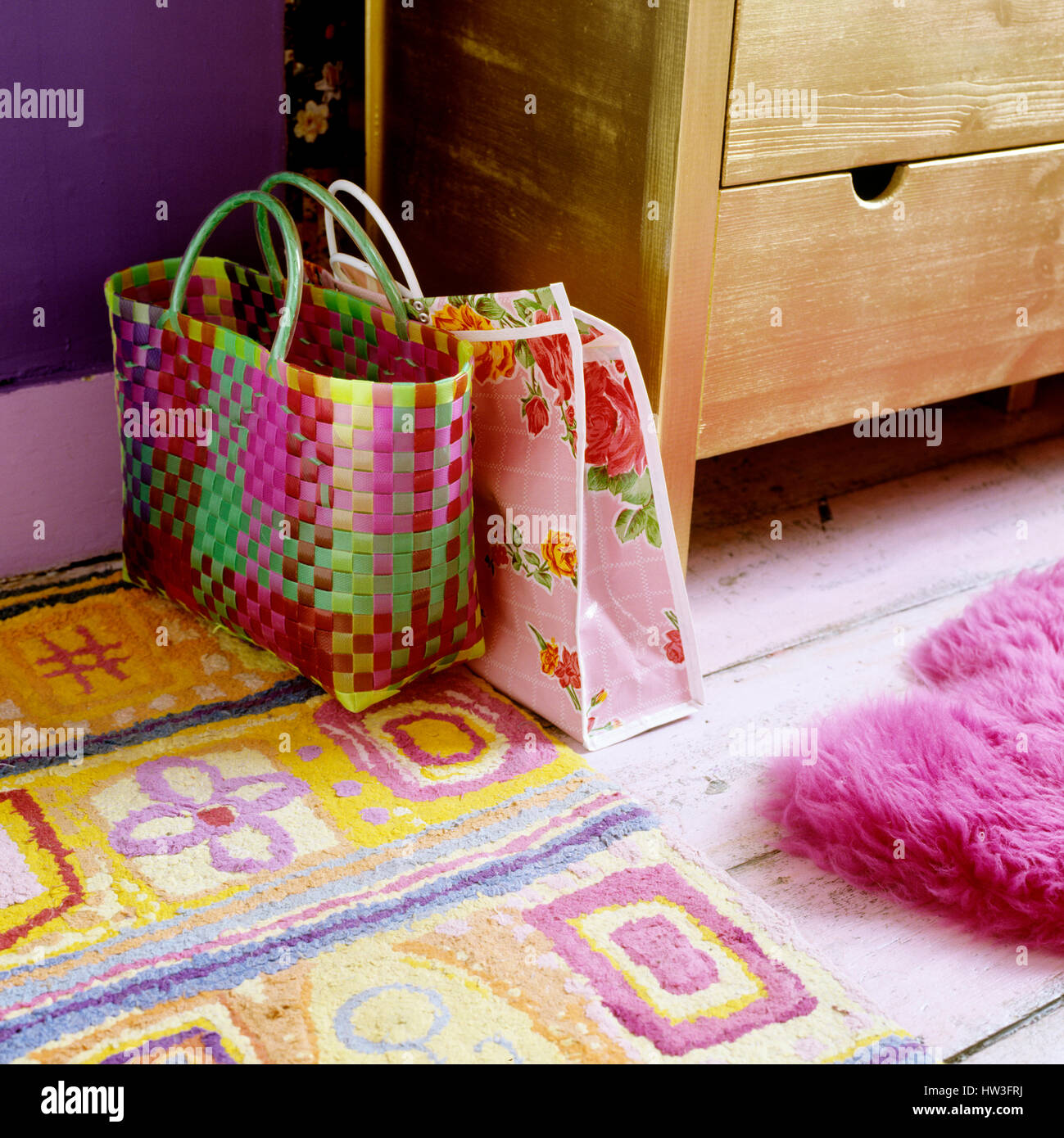Colorful bags by floral rug. Stock Photo
