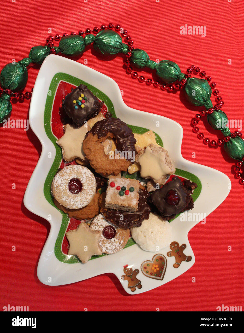 home baked christmas biscuits on a tree-shaped ceramic plate Stock Photo