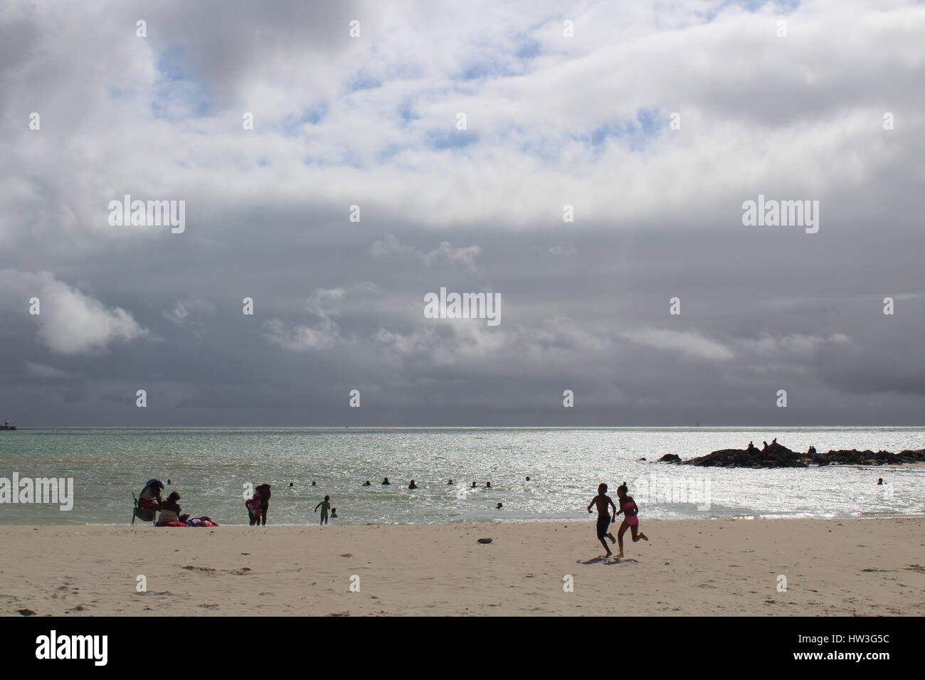 Children running on Gordons Bay beach, Western Cape, South Africa Stock Photo