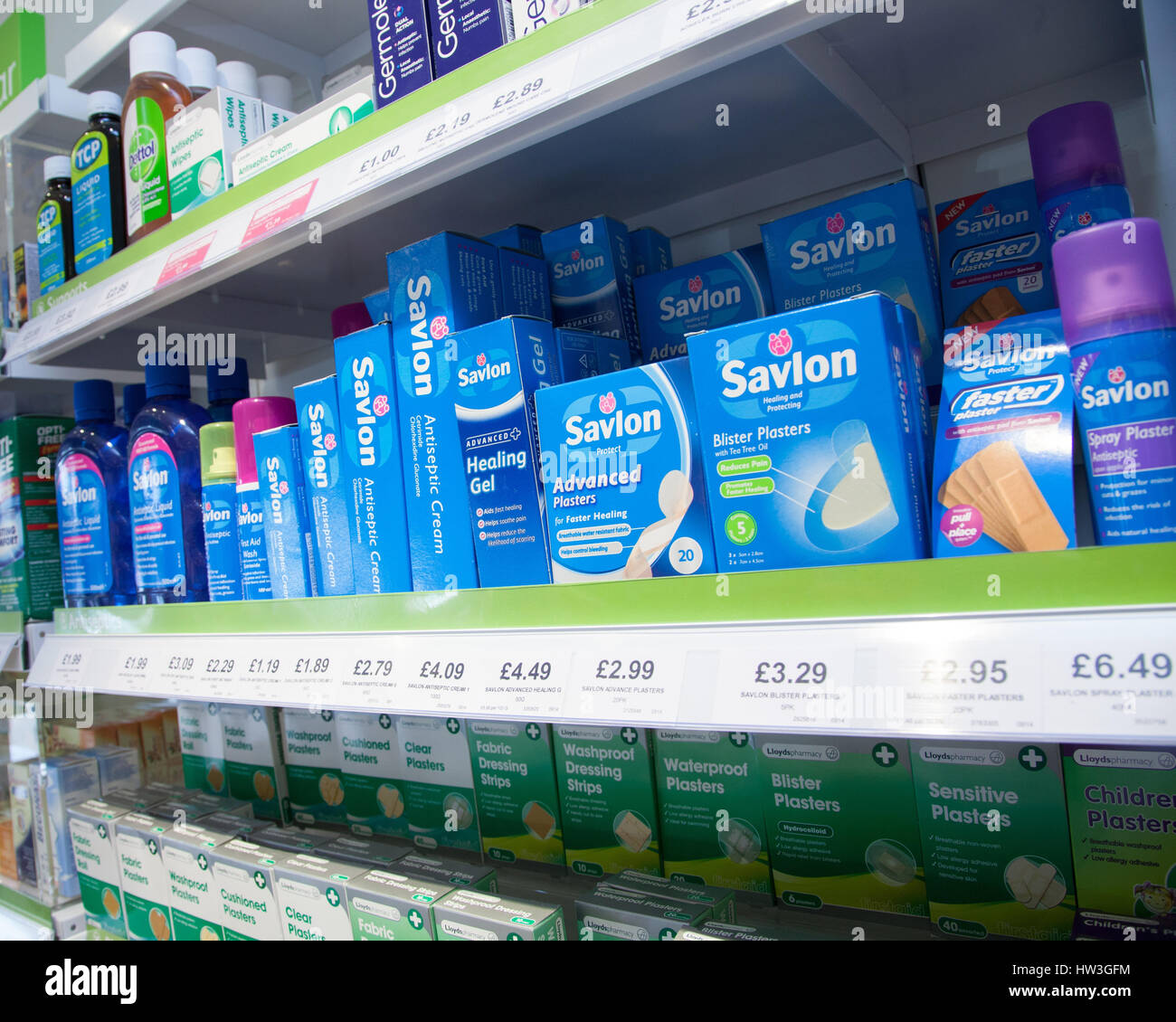 Plasters and antiseptic cream Savlon and Germolene on the shelves of a pharmacy shop. Stock Photo