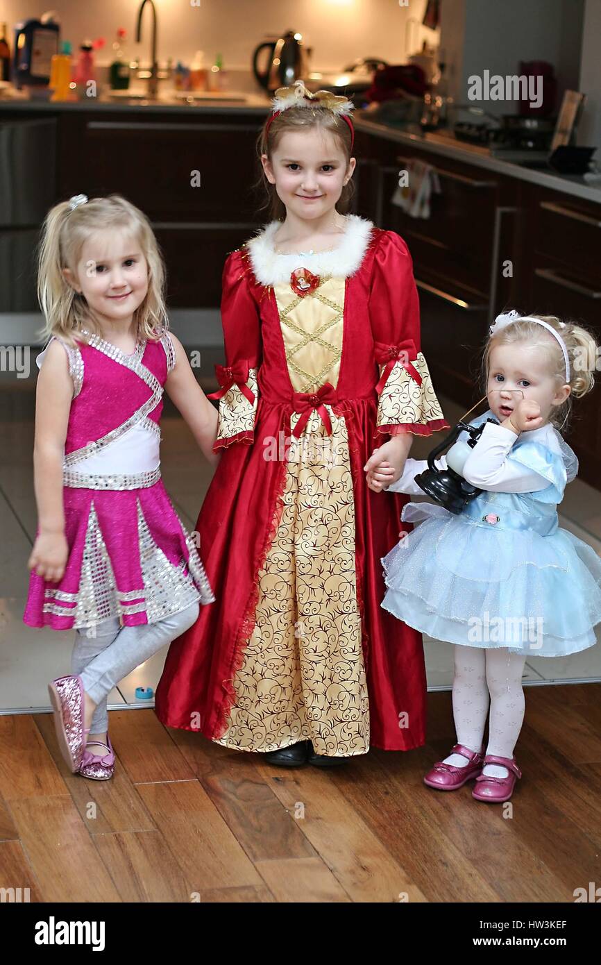 Little girls children kids family dressed up in fancy dress disney costumes Stock Photo