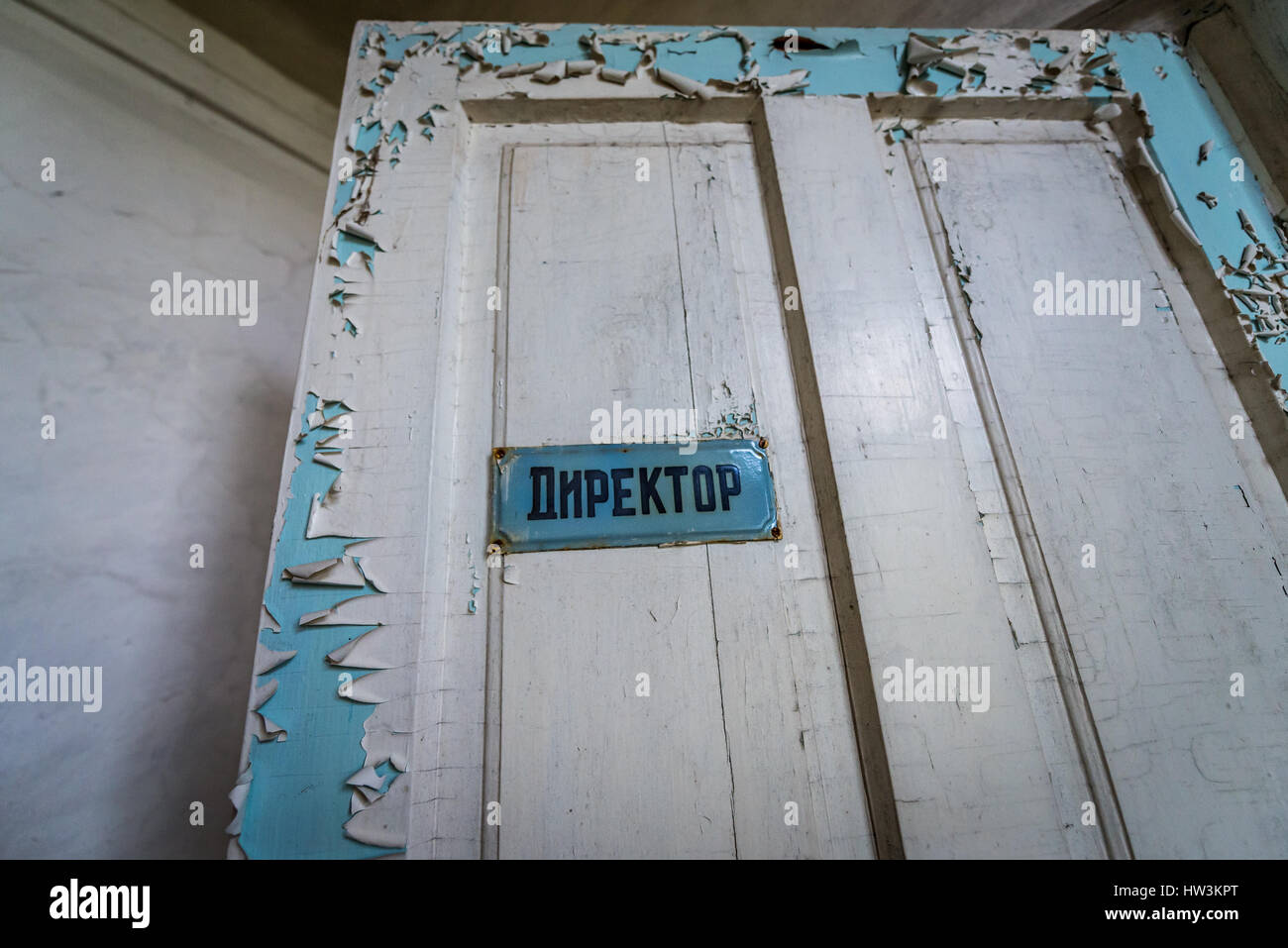 Door of headmaster office in secondary school in Mashevo abandoned village of Chernobyl Nuclear Power Plant Zone of Alienation in Ukraine Stock Photo