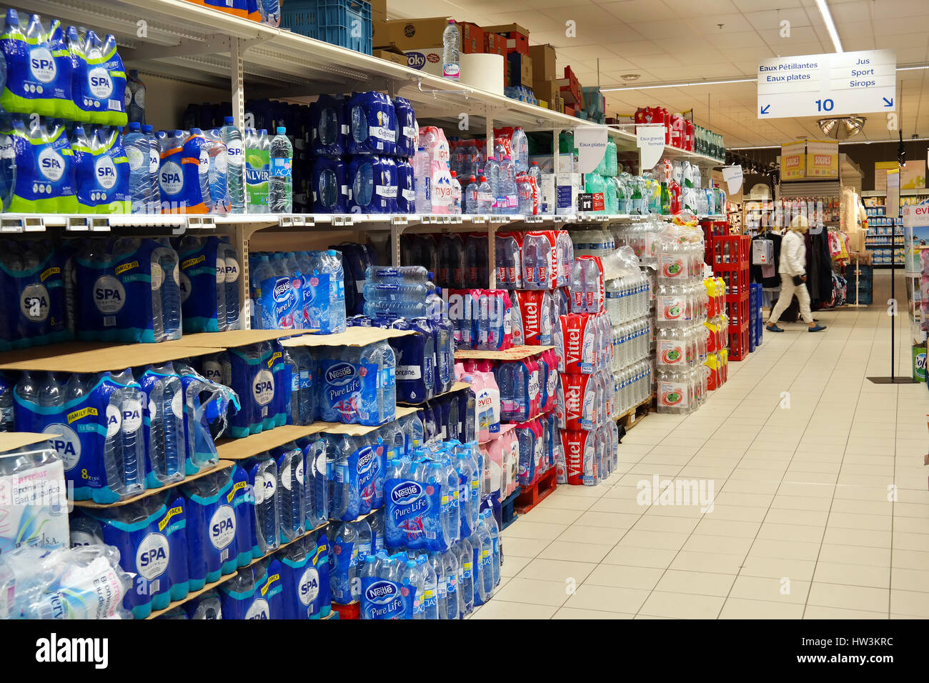 Aisle with bottles mineral water in a Carrefour Hypermarket Stock Photo