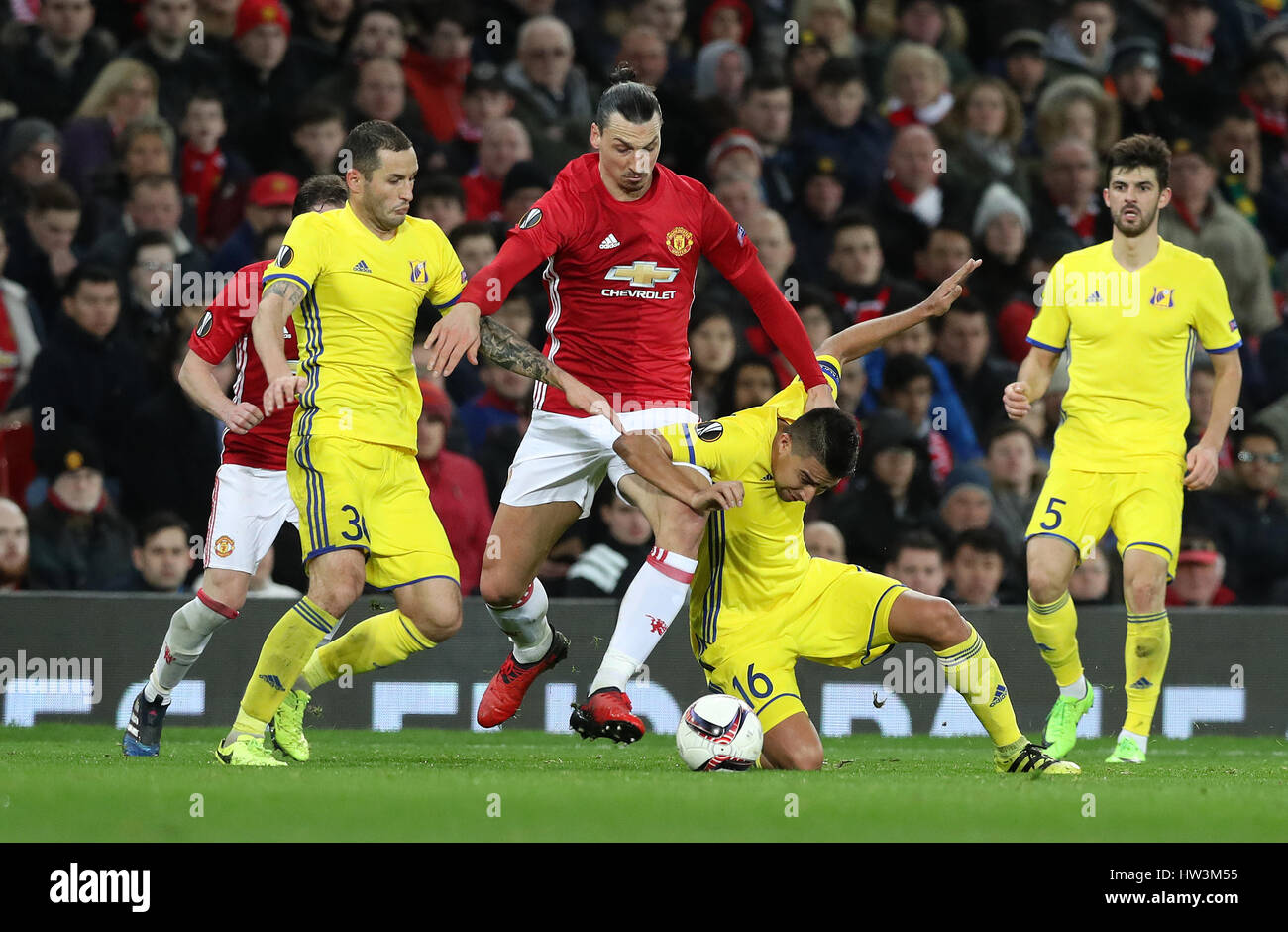 Manchester United's Zlatan Ibrahimovic is tackled by FC Rostov's Fedor Kudryashov and Cristian Noboa during the UEFA Europa League Round of Sixteen, Second Leg match at Old Trafford, Manchester. Stock Photo