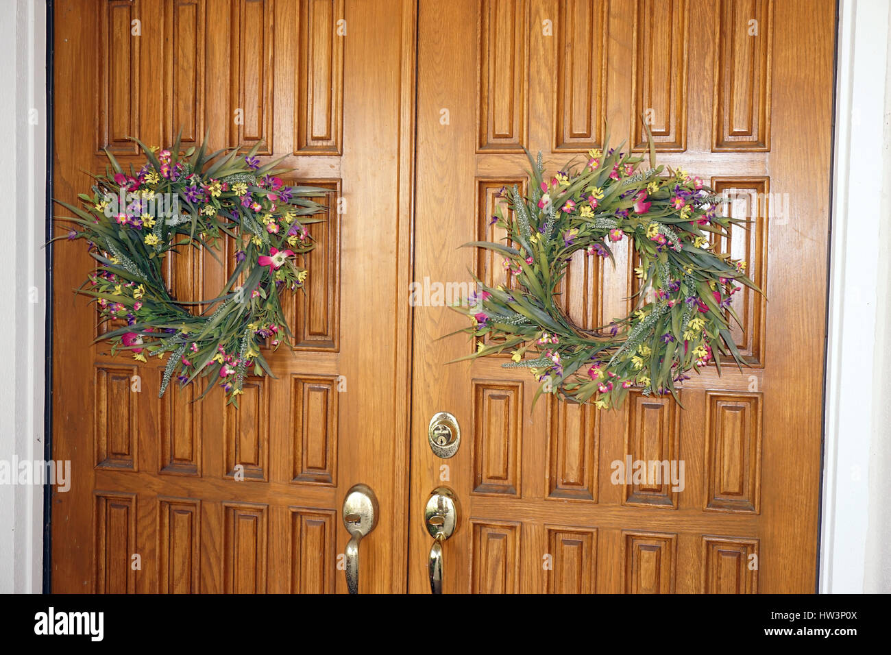 Oak double entrance doors with Spring wreaths Stock Photo Alamy