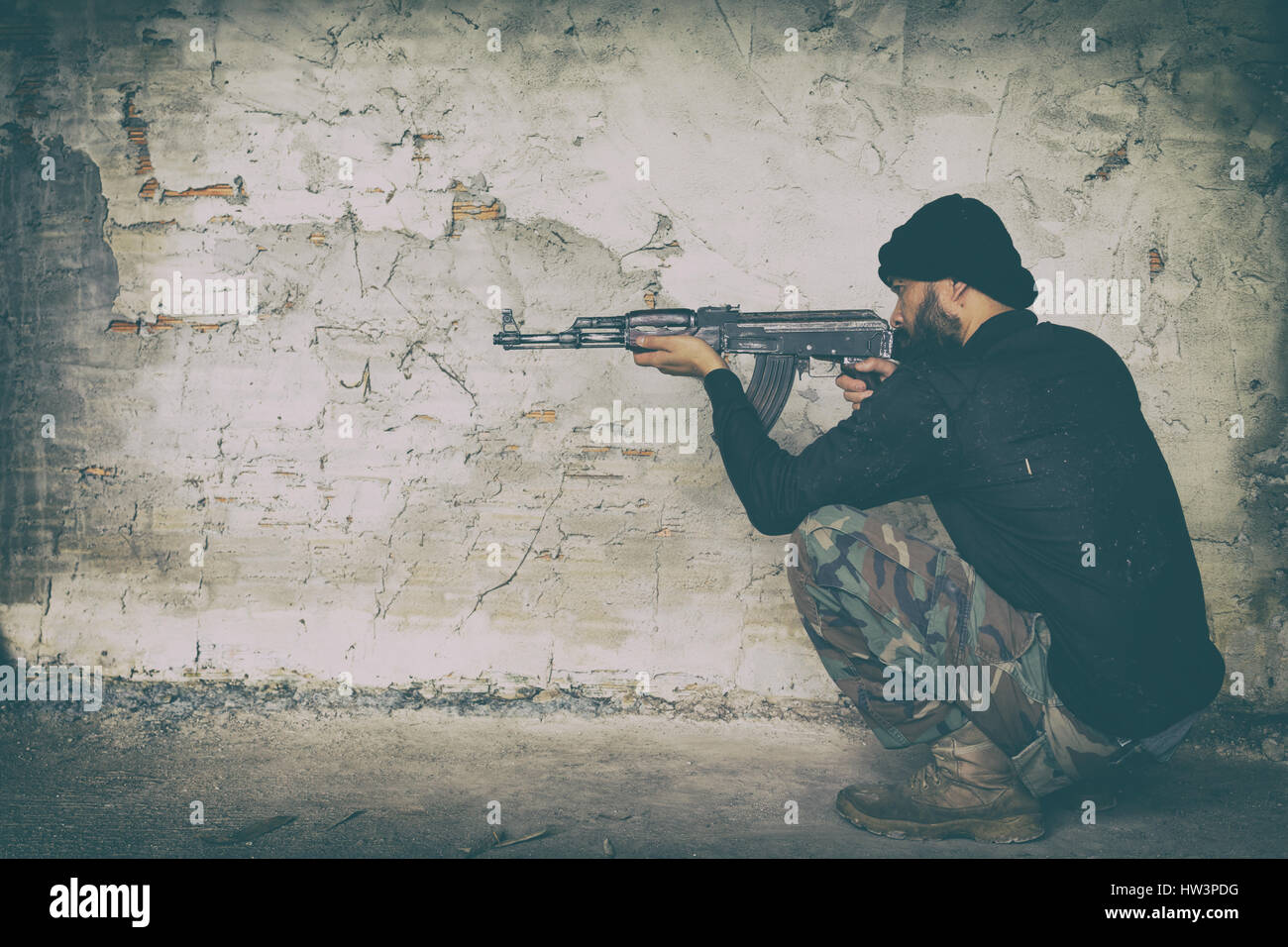 terrorist in black uniform and mask with kalashnikov ak47 Stock Photo