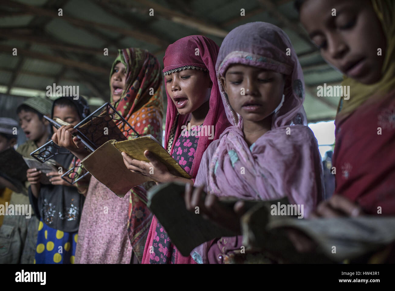 March 7, 2017 - Cox'S Bazar, Chittagong, Bangladesh - Rohingya refugee children attend an Arabic school in Kutupalang Refugee Camp, where they learn to read the Quran, in Cox's Bazar, Bangladesh, March 7, 2017. About 70,000 Rohingya Muslims have fled to Bangladesh from Myanmar since October 9, 2016 after the Burmese military launched clearance operations in response to an attack on border police. There are more than 30,000 registered refugees in Bangladesh but authorities estimate that 300,000 to 500,000 unregistered Rohingya are also already living here. As a result, most of these unregistere Stock Photo