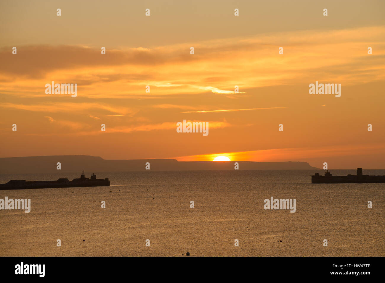 Sandsfoot Castle, Weymouth, Dorset, UK. 17th March 2017. Portland harbour on a spectacular and vibrant sunrise on the south coast. © Dan Tucker/Alamy Live News Stock Photo