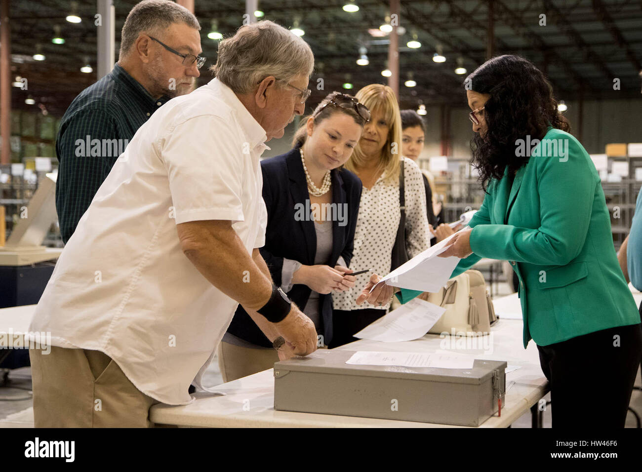 Riviera Beach, Florida, USA. 17th Mar, 2017. Supervisor of Elections Susan Bucher (right) shows results of the recounted Lantana town council race to winner Edward Paul Shropshire (foreground) and Thomas Deringer (left) at the supervisor of elections service center in Riviera Beach, Florida on March 17, 2017. Two votes separated the race between Edward Paul Shropshire and Thomas Deringer with Shropshire confirmed as the winner. Credit: Allen Eyestone/The Palm Beach Post/ZUMA Wire/Alamy Live News Stock Photo