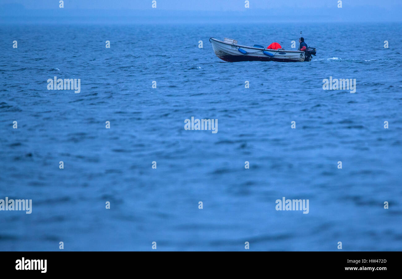 Wismar, Germany. 17th Mar, 2017. A fishing boat off the coast of Wismar, Germany, 17 March 2017. The fishing industry in the state of Mecklenburg-Western Pomerania is currently threatened by a combination of sinking EU fishing quotas, low demand, and rising costs. The area used to support some 170 fishing operations; today only three remain. Photo: Jens Büttner/dpa-Zentralbild/dpa/Alamy Live News Stock Photo