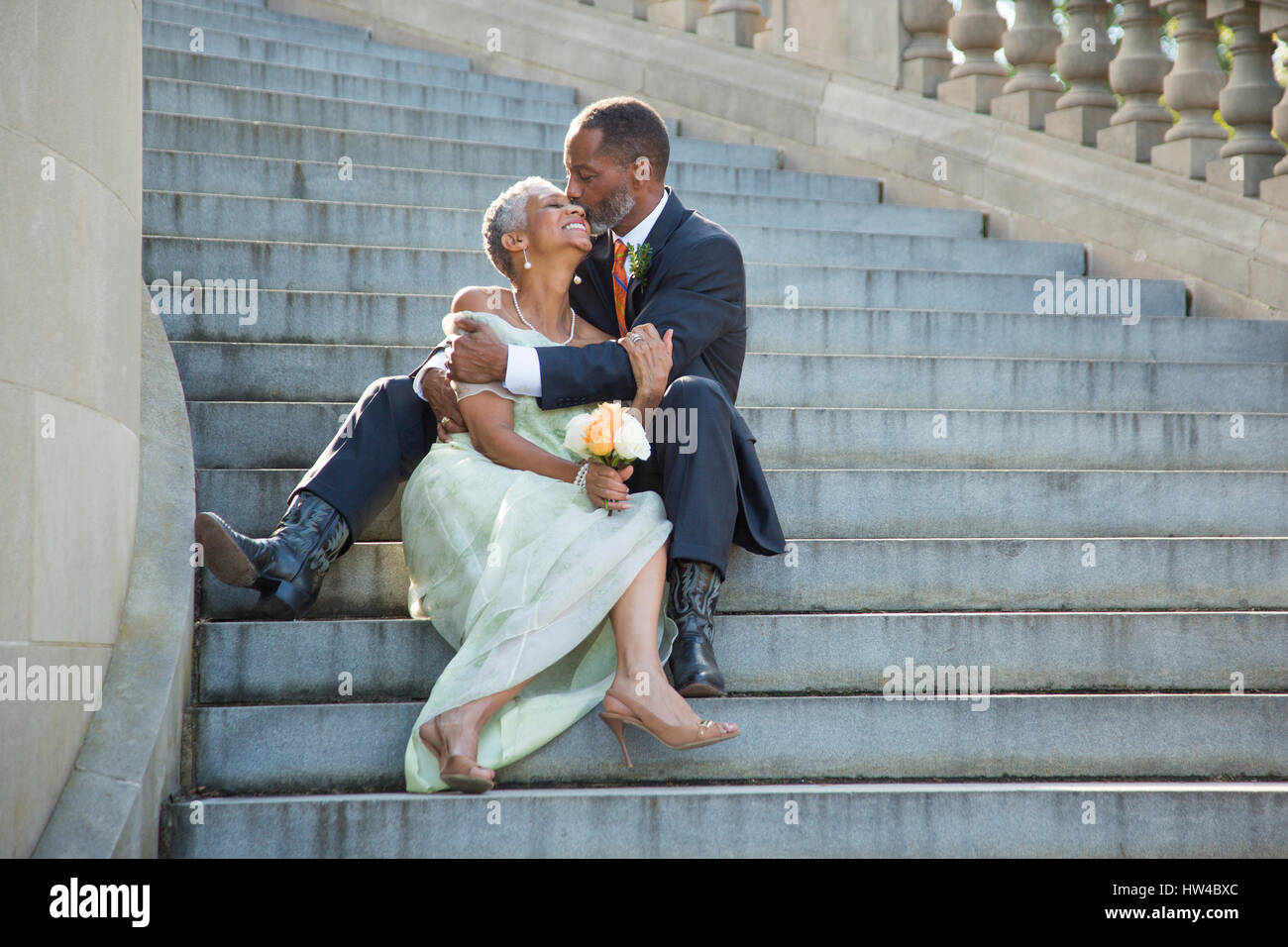 Black couple kissing on stone staircase Stock Photo