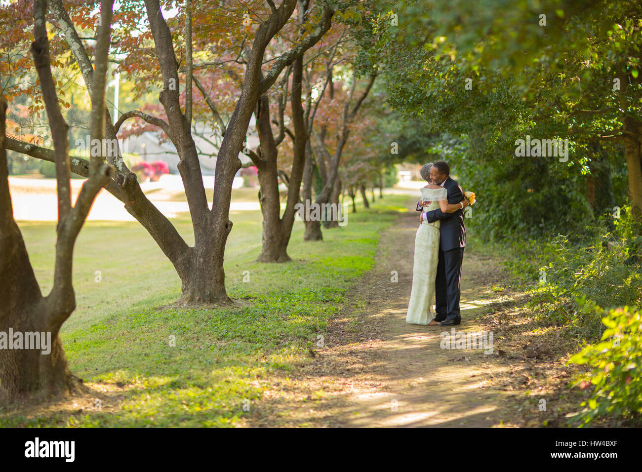 Black couple hugging on path in park Stock Photo - Alamy