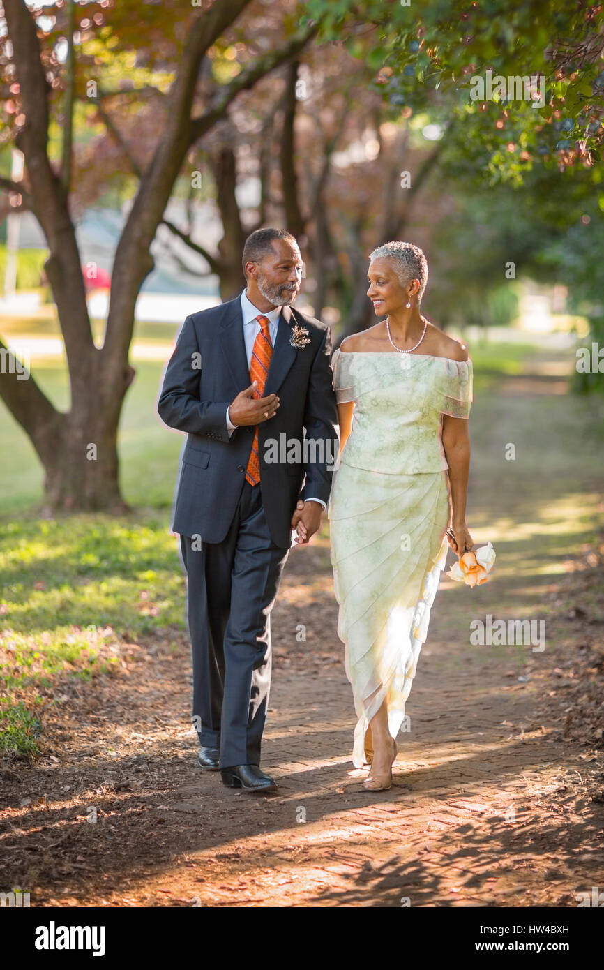 Black couple walking on path in park Stock Photo