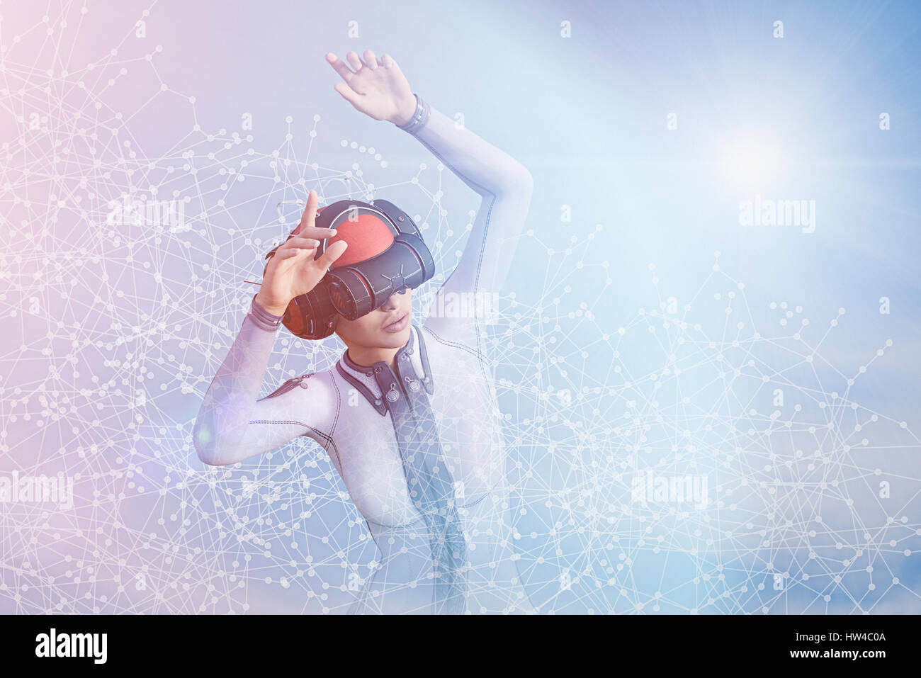 Woman with arms raised using virtual reality helmet Stock Photo