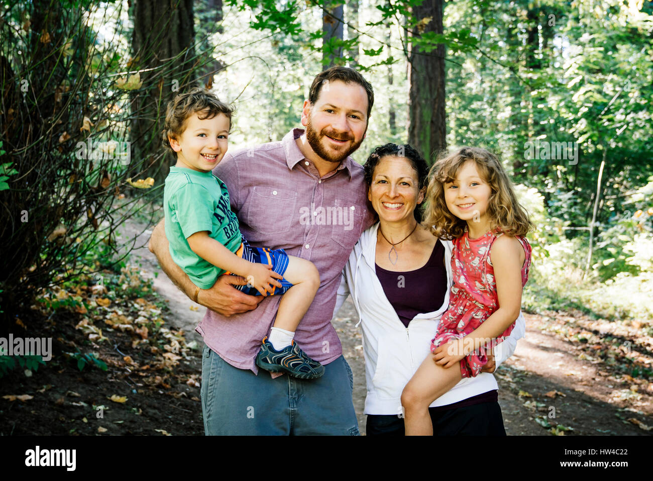 Portrait of smiling Caucasian family in park Stock Photo