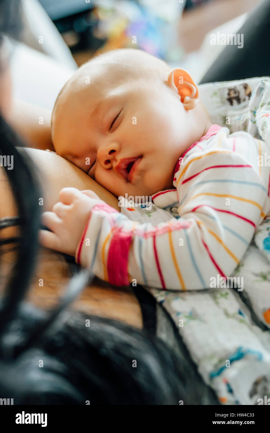 Mother holding sleeping baby daughter Stock Photo
