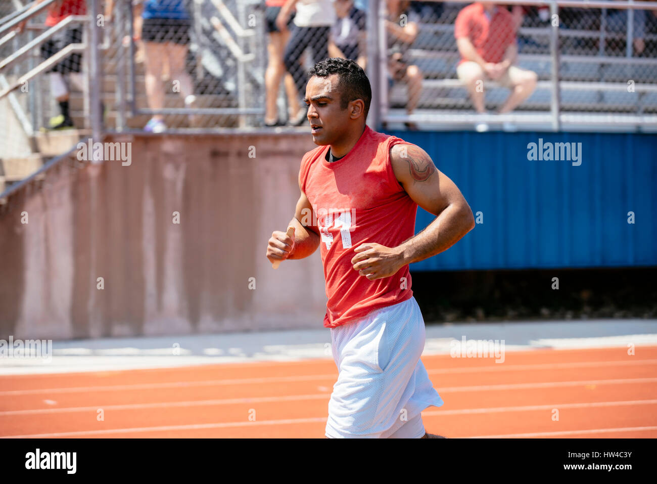 Hispanic man running on track Stock Photo