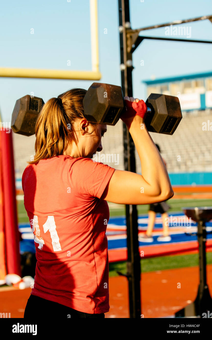 Caucasian woman lifting weights outdoors Stock Photo