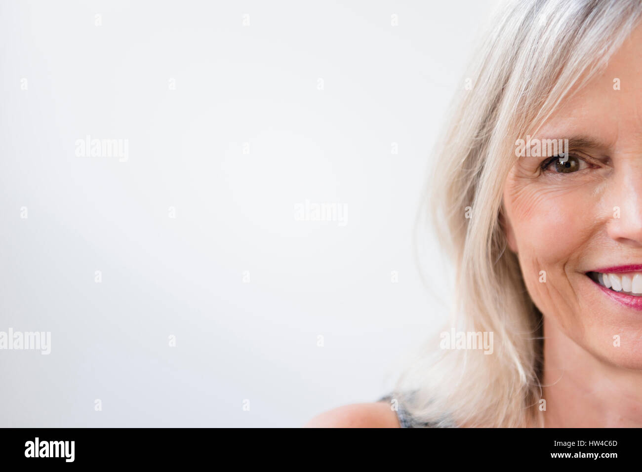 Portrait of half of face of smiling Caucasian woman Stock Photo