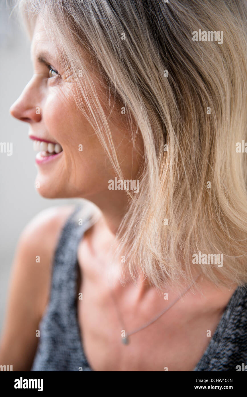 Smiling Caucasian woman looking away Stock Photo