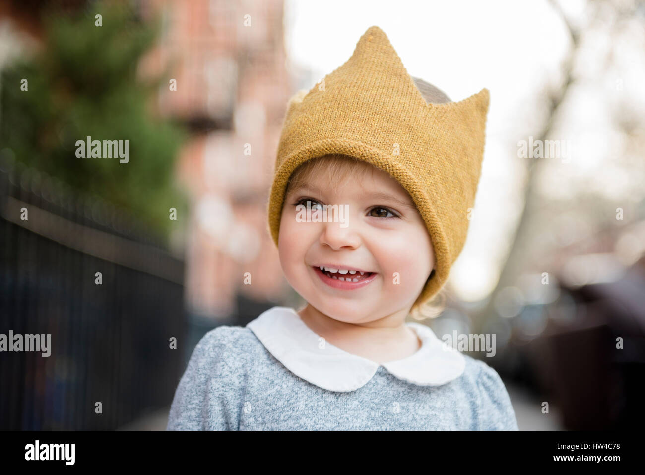Smiling Caucasian baby girl wearing crown hat Stock Photo