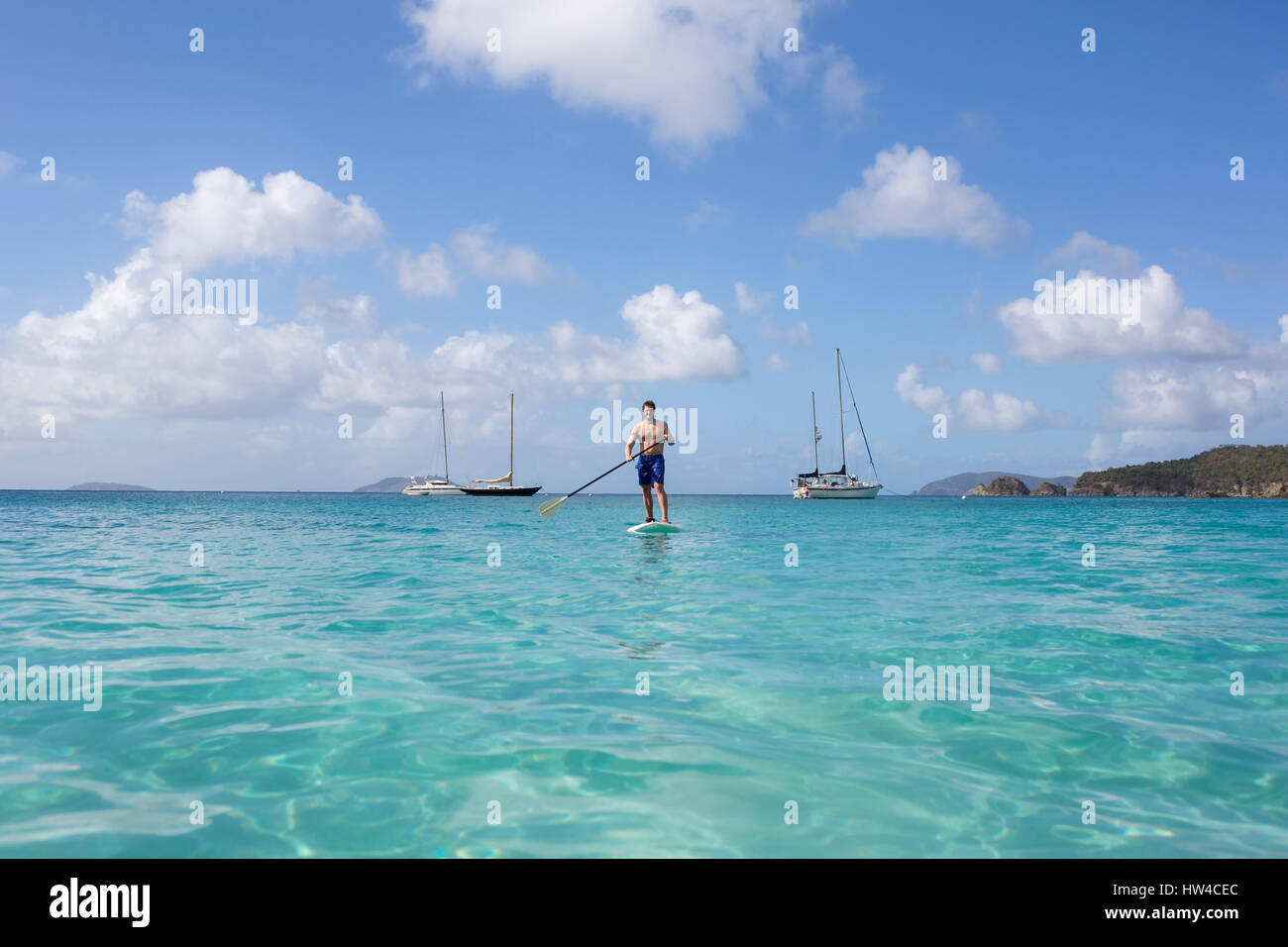 Caucasian man standing on paddle board on ocean Stock Photo