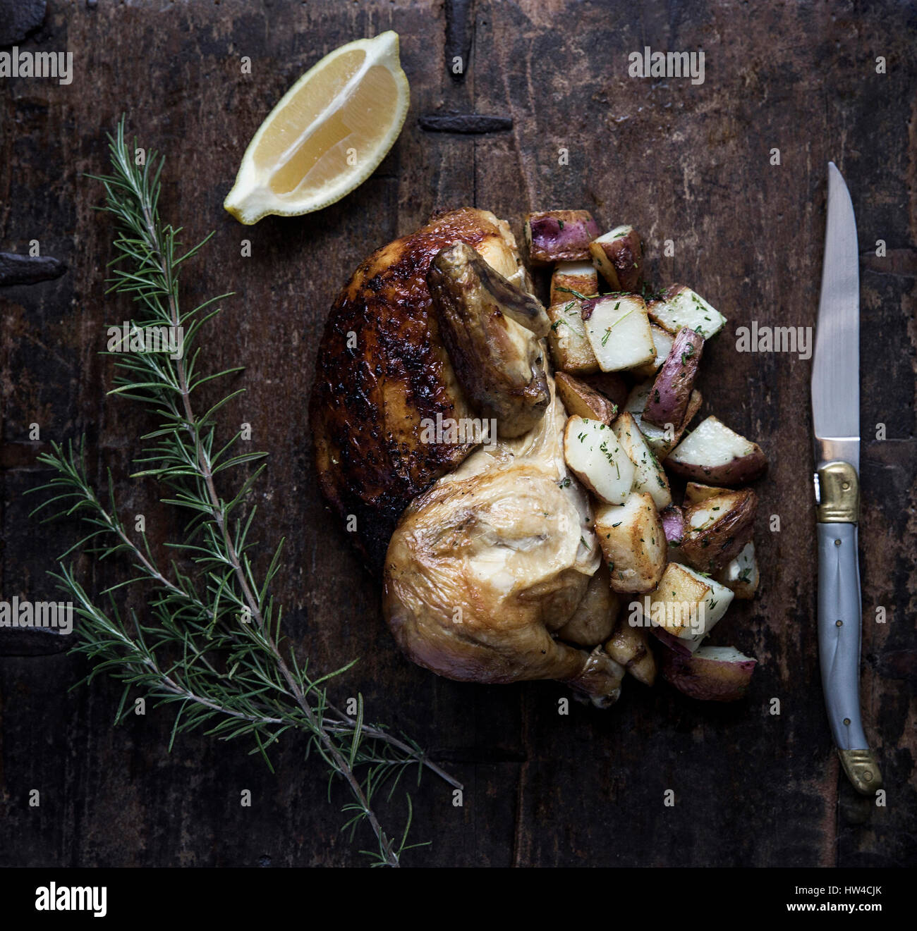 Roasted chicken with potatoes and lemon Stock Photo