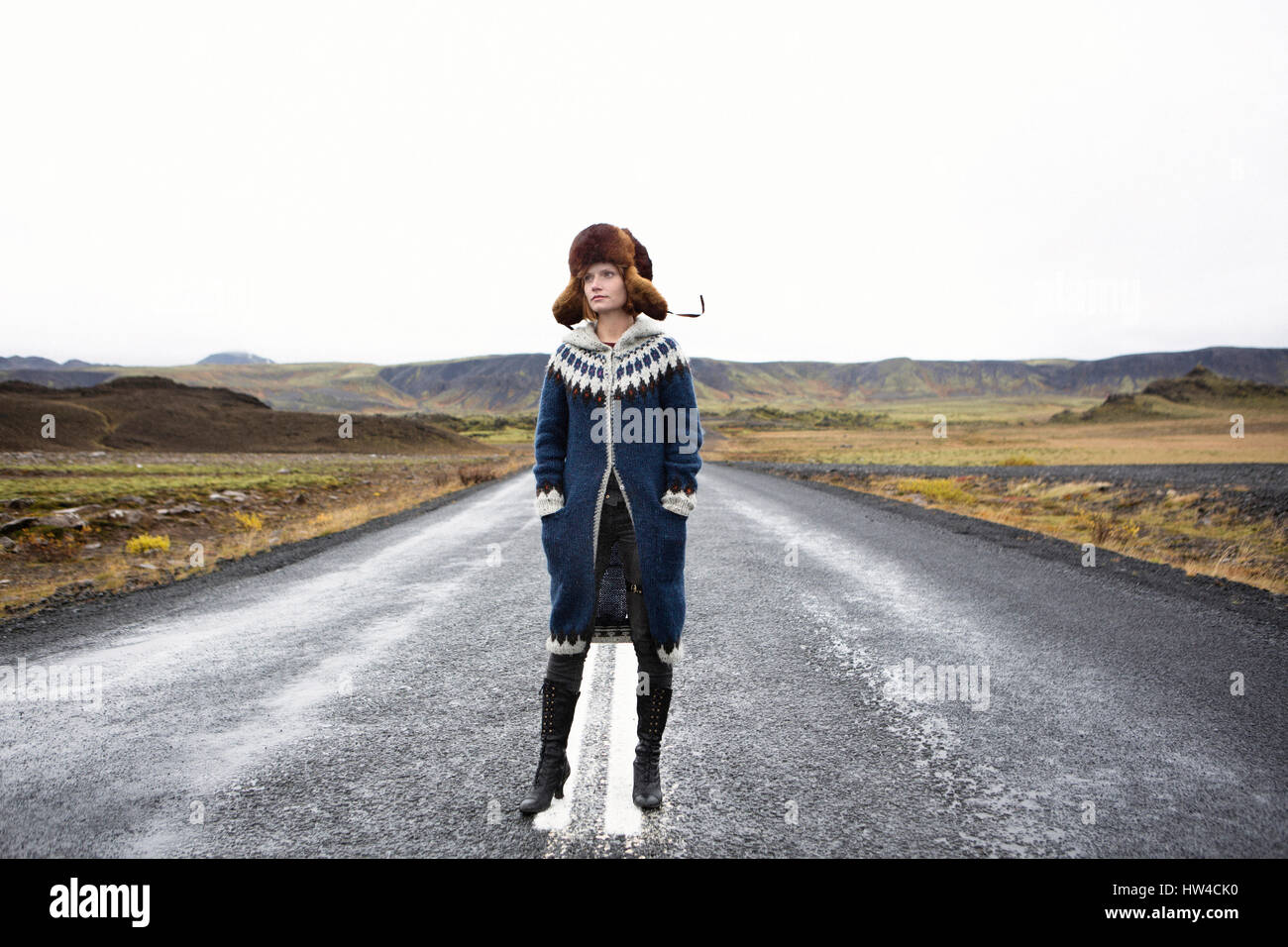Caucasian woman standing in middle of road Stock Photo
