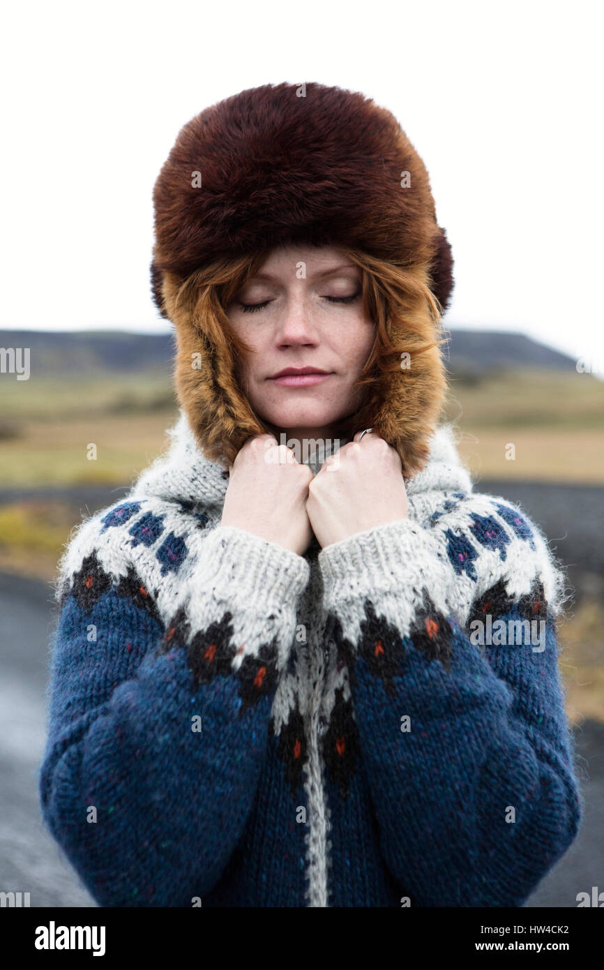 Caucasian woman wearing sweater and fur hat Stock Photo