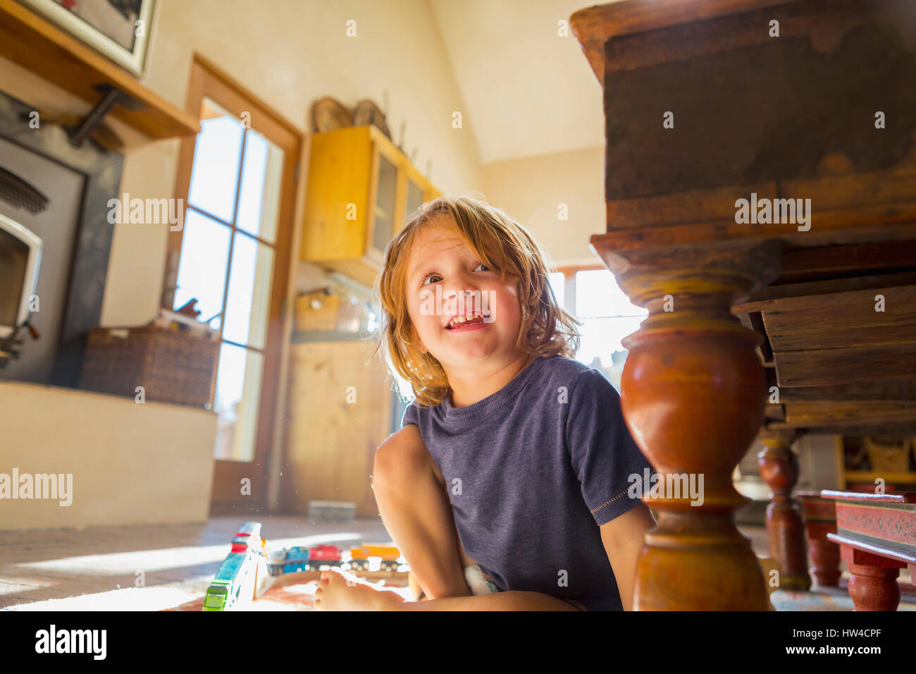 Caucasian boy playing with toy race track on floor Stock Photo