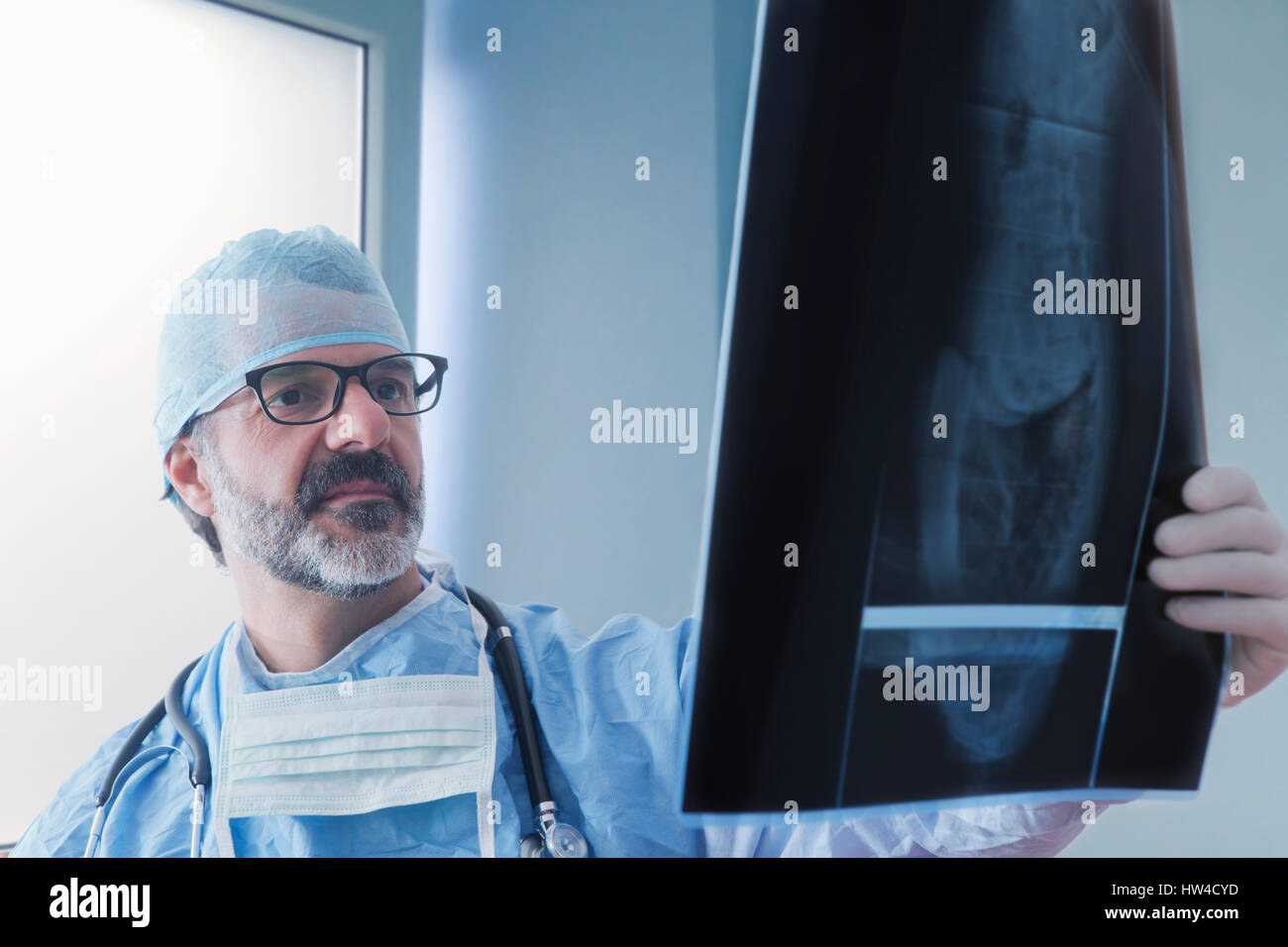Hispanic surgeon examining x-ray Stock Photo