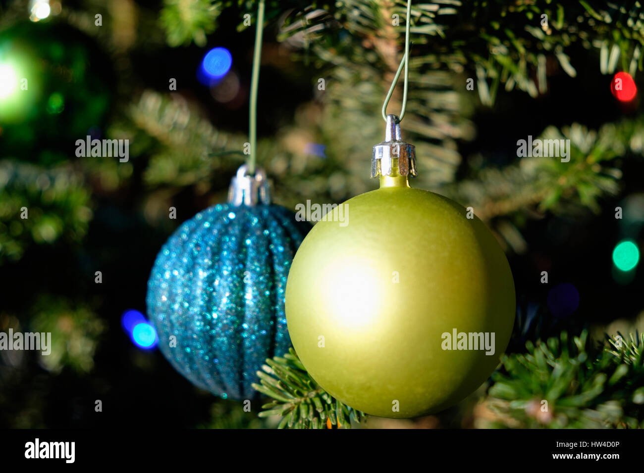Blue and green ornaments hanging on Christmas tree Stock Photo