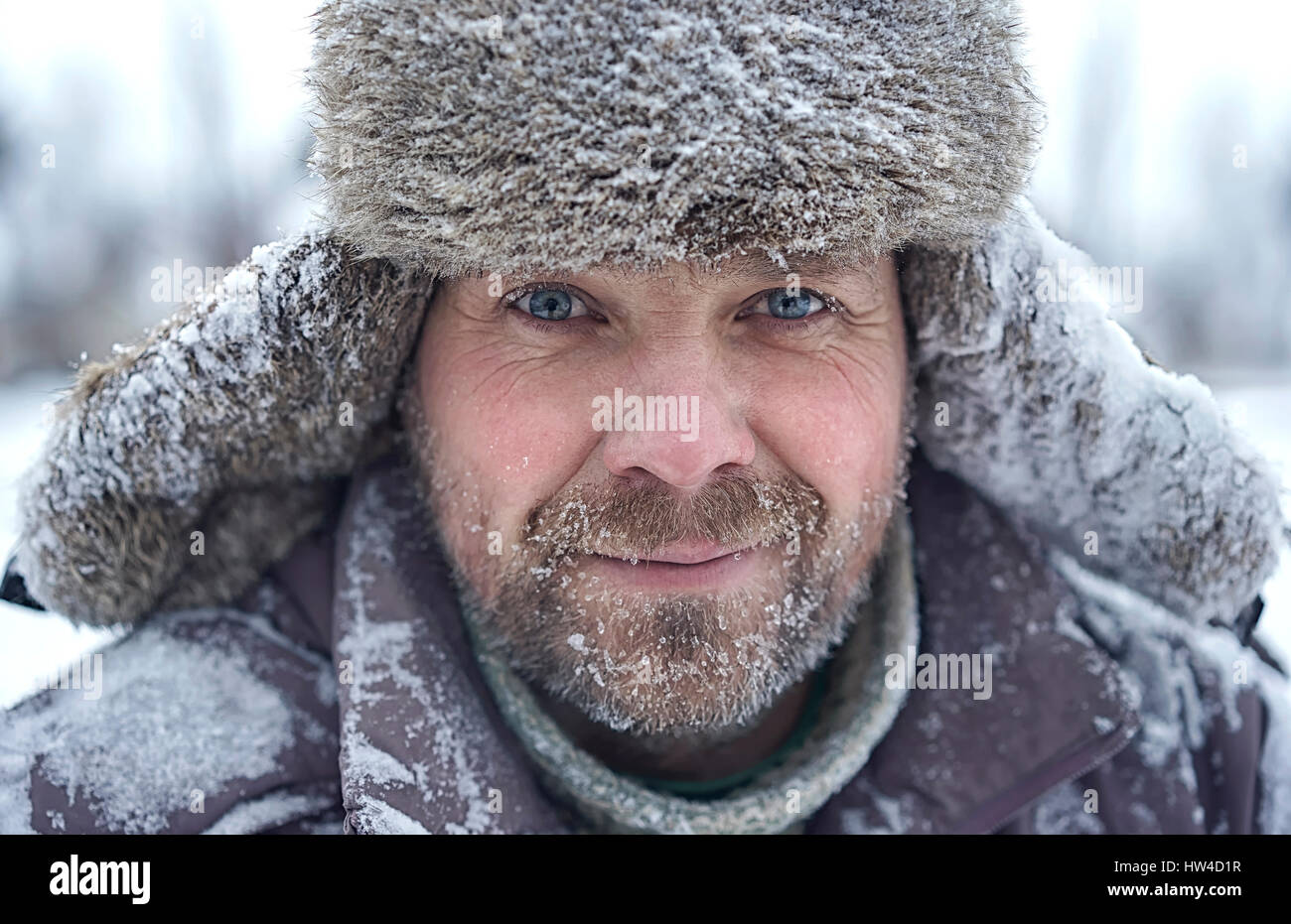 Portrait of Caucasian man with ice in bear in winter Stock Photo
