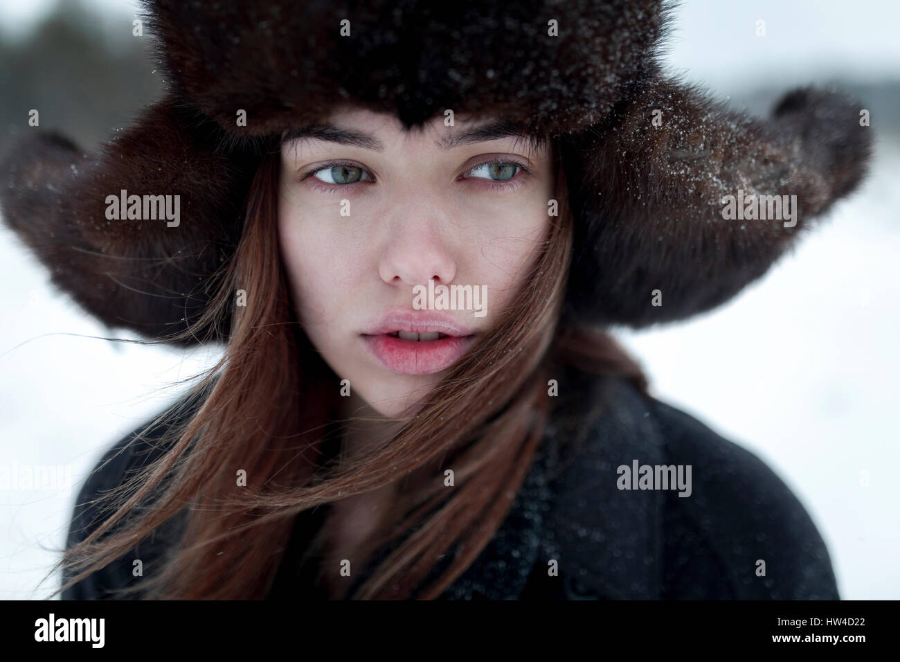 Serious Caucasian woman wearing fur hat and coat in winter Stock Photo