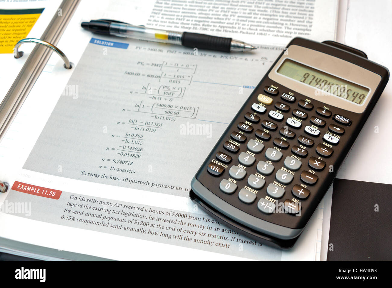 Calculator, pen and text book, illustrating a math problem Stock Photo -  Alamy