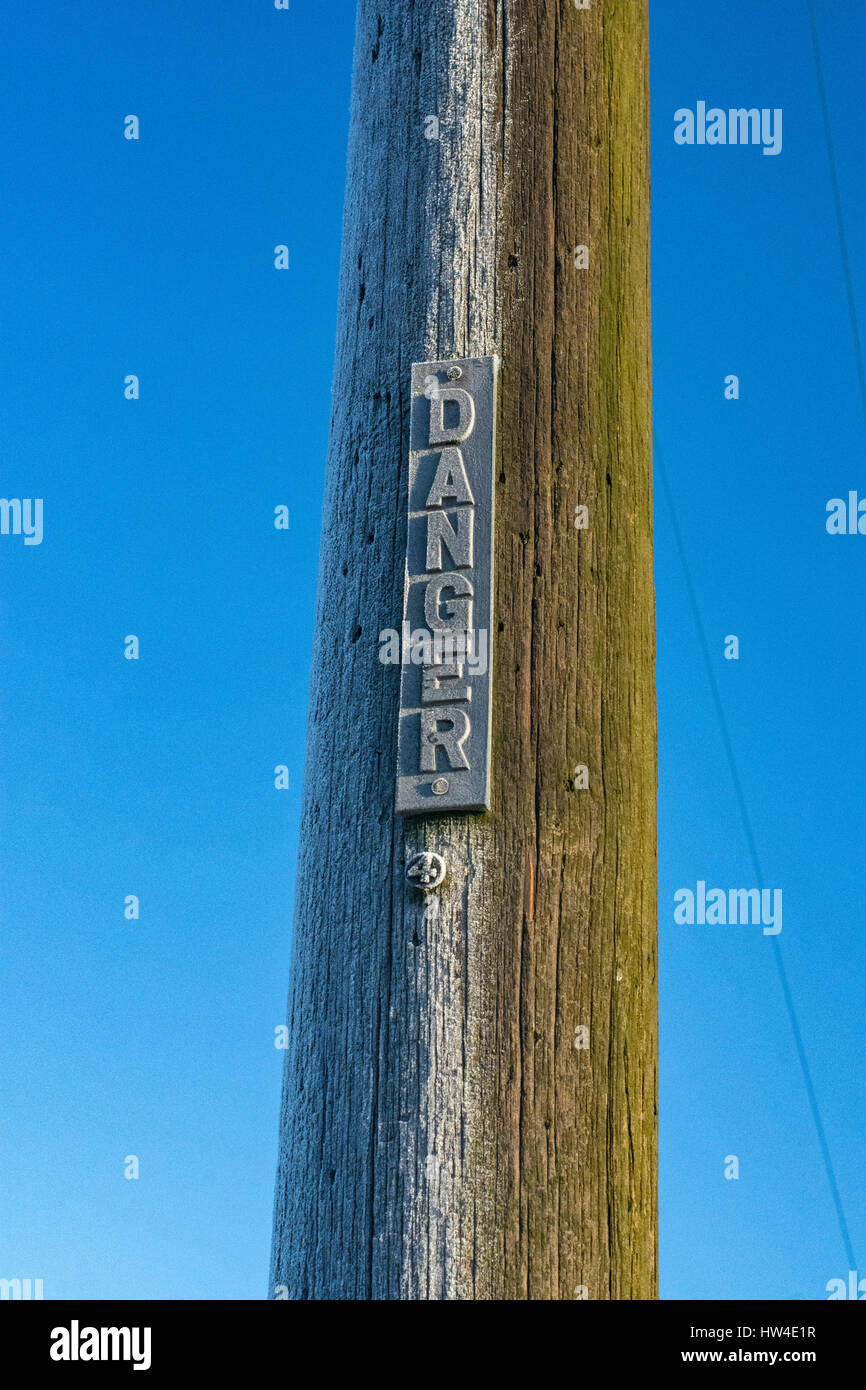 Frost left on half a power pole in the winter sun Stock Photo