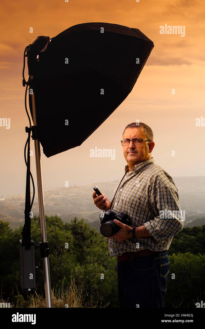 Photographer assistant measuring the light in a photo shoot outdoors at