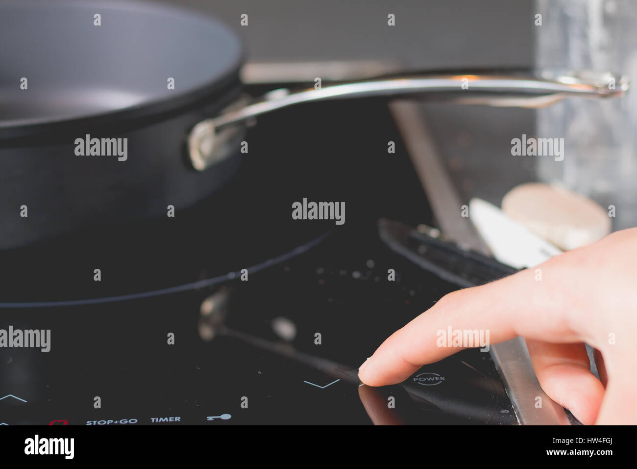 Cook who starts Induction Cooktops in a kitchen Stock Photo Alamy