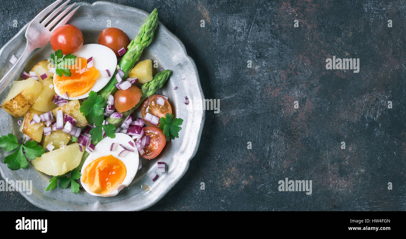 Spring asparagus salad in vintage plate on grunge background with copy space Stock Photo