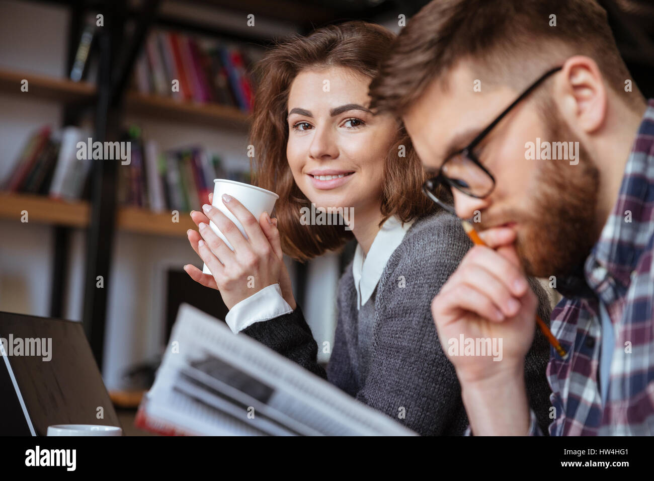 Two young university students studying in library Stock Photo - Alamy