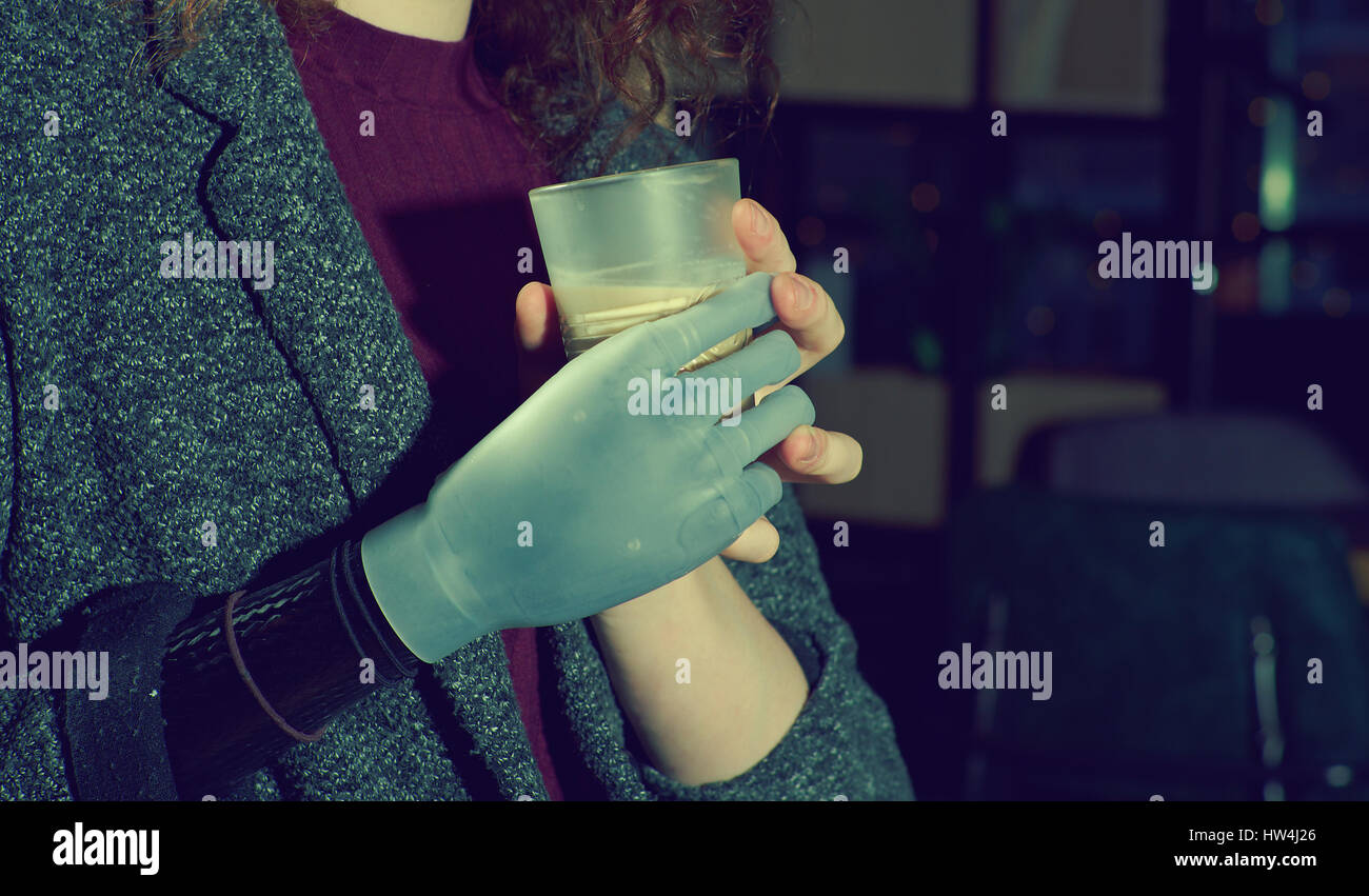 Young woman with prosthetic arm drinks cofee Stock Photo Alamy