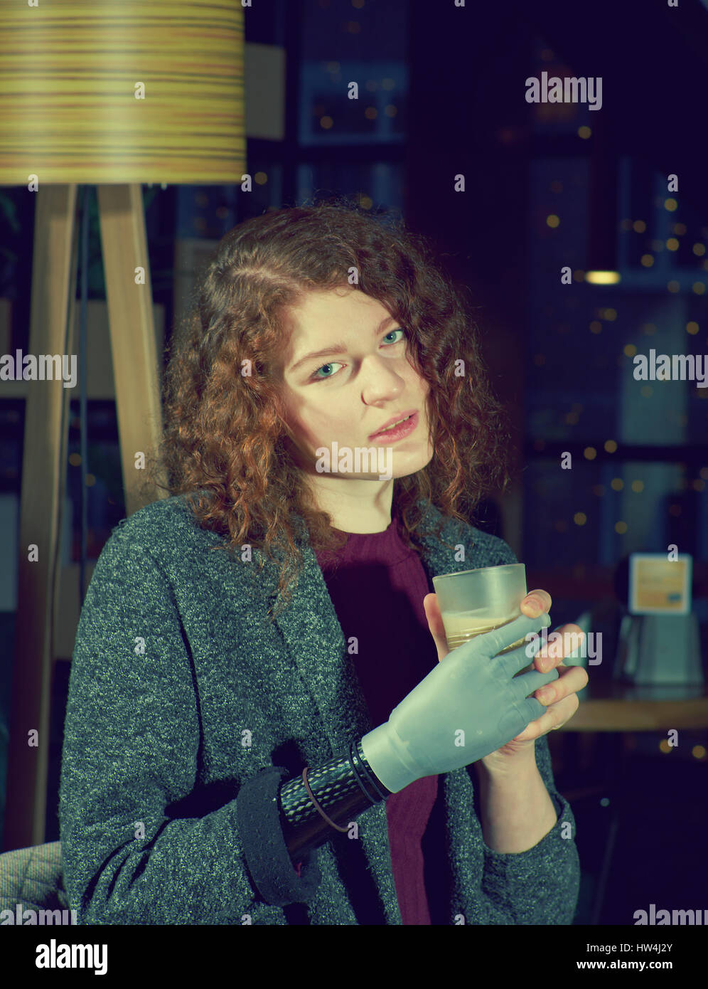Young woman with prosthetic arm drinks cofee Stock Photo Alamy