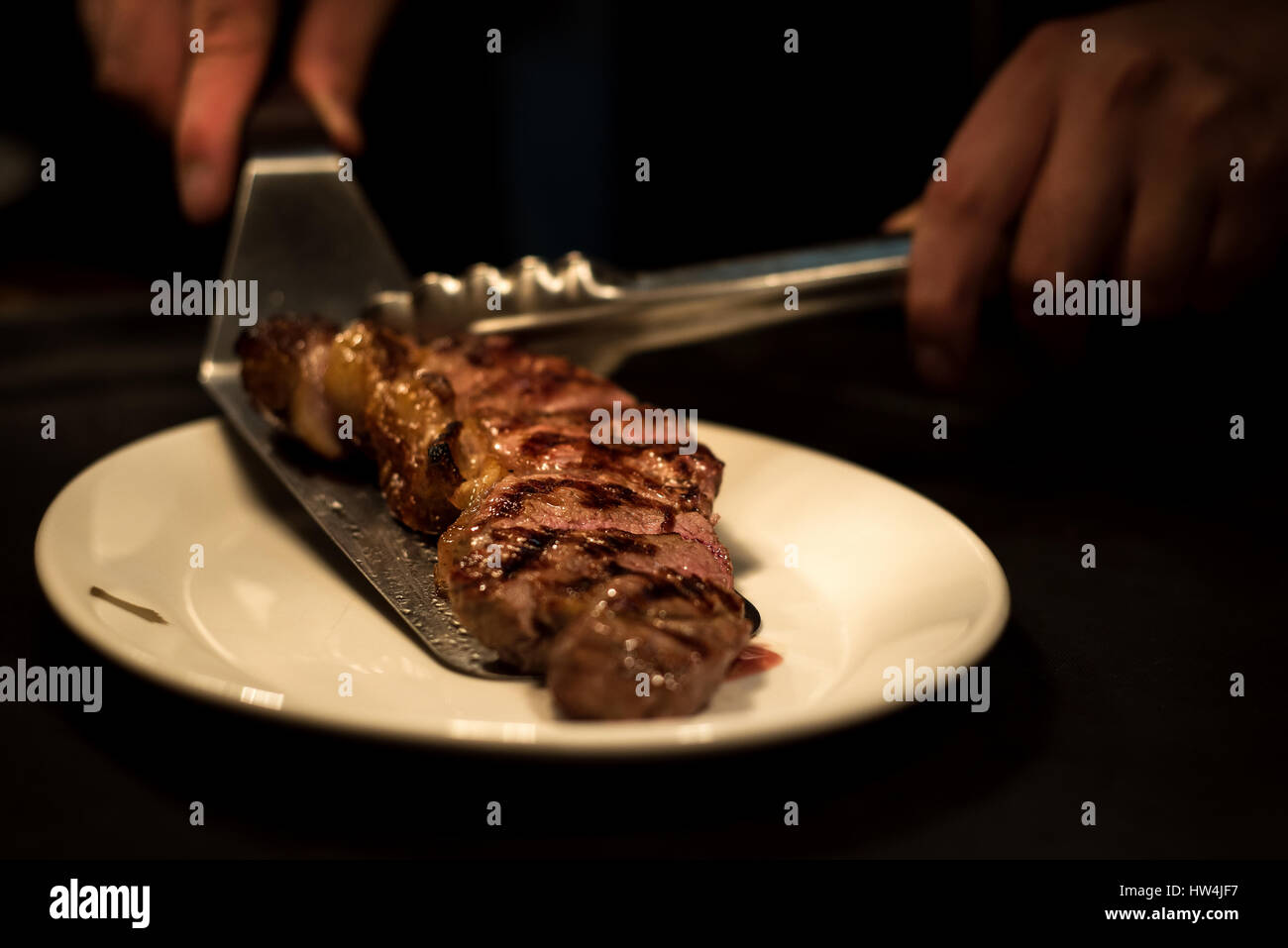 Chef plating a steak Stock Photo