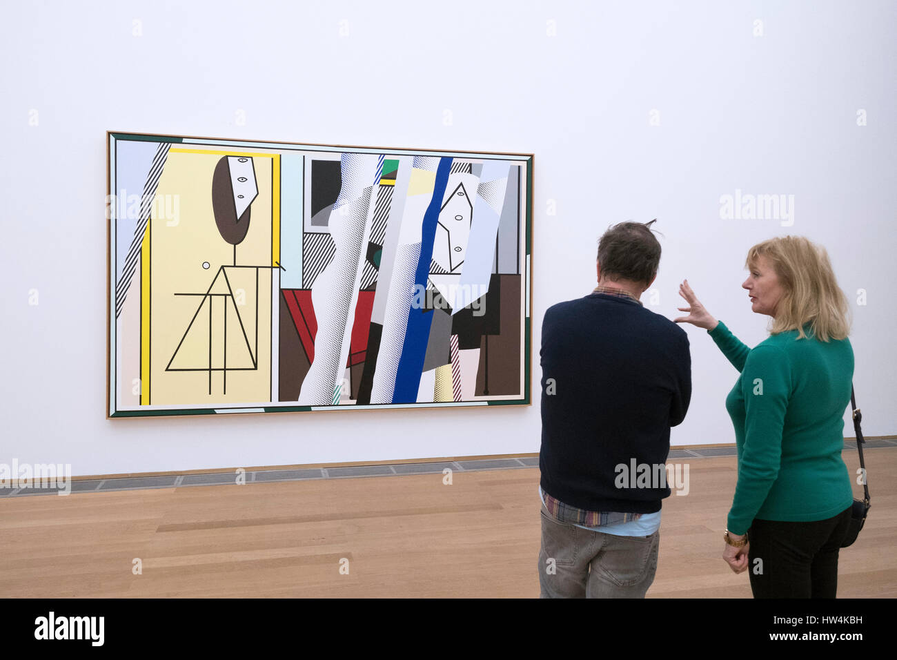 Visitors looking at painting Reflections On 'The Artist's Studio' by Roy Lichtenstein at Hamburger Bahnhof modern art museum in Berlin, Germany Stock Photo