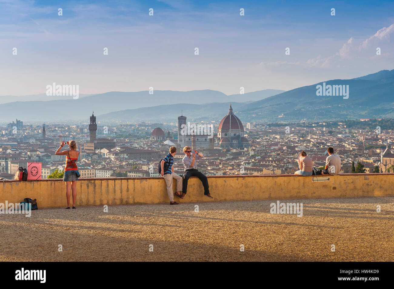 Florence tourism, view of tourists gathered on a hillside terrace overlooking the scenic city of Florence just before sunset, Firenze,Tuscany, Italy. Stock Photo