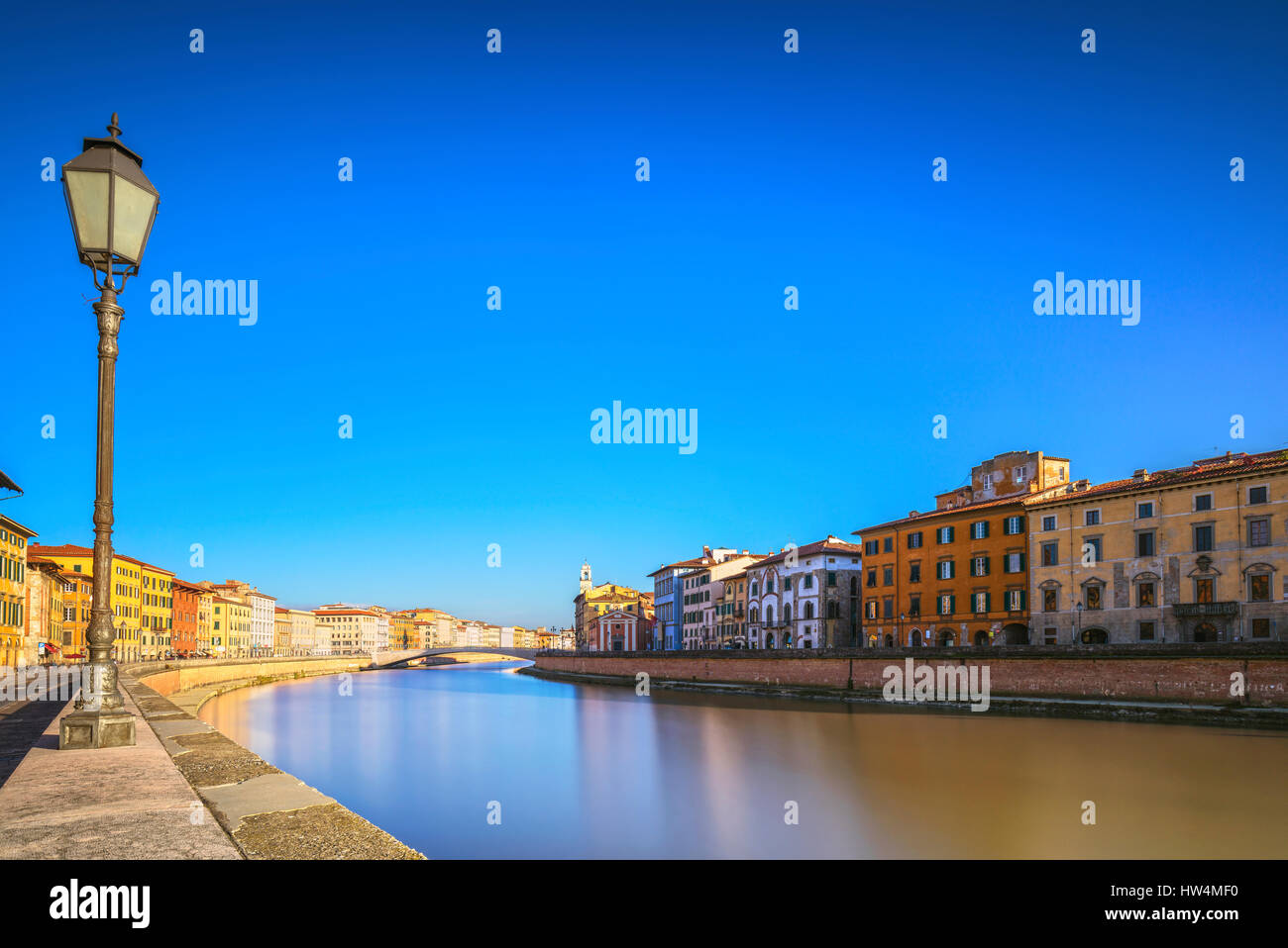 Pisa, Arno river, lamp and building facades reflection. Lungarno view. Long Exposure. Tuscany, Italy, Europe. Stock Photo