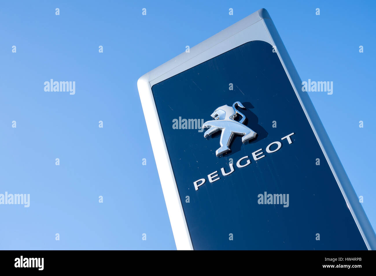 Peugeot dealership sign against blue sky Stock Photo