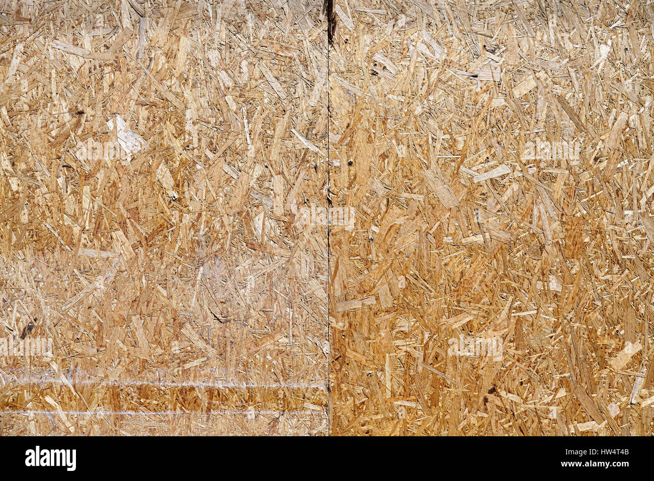 An old oriented strand board (OSB), fiberboard background of texture. Stock Photo