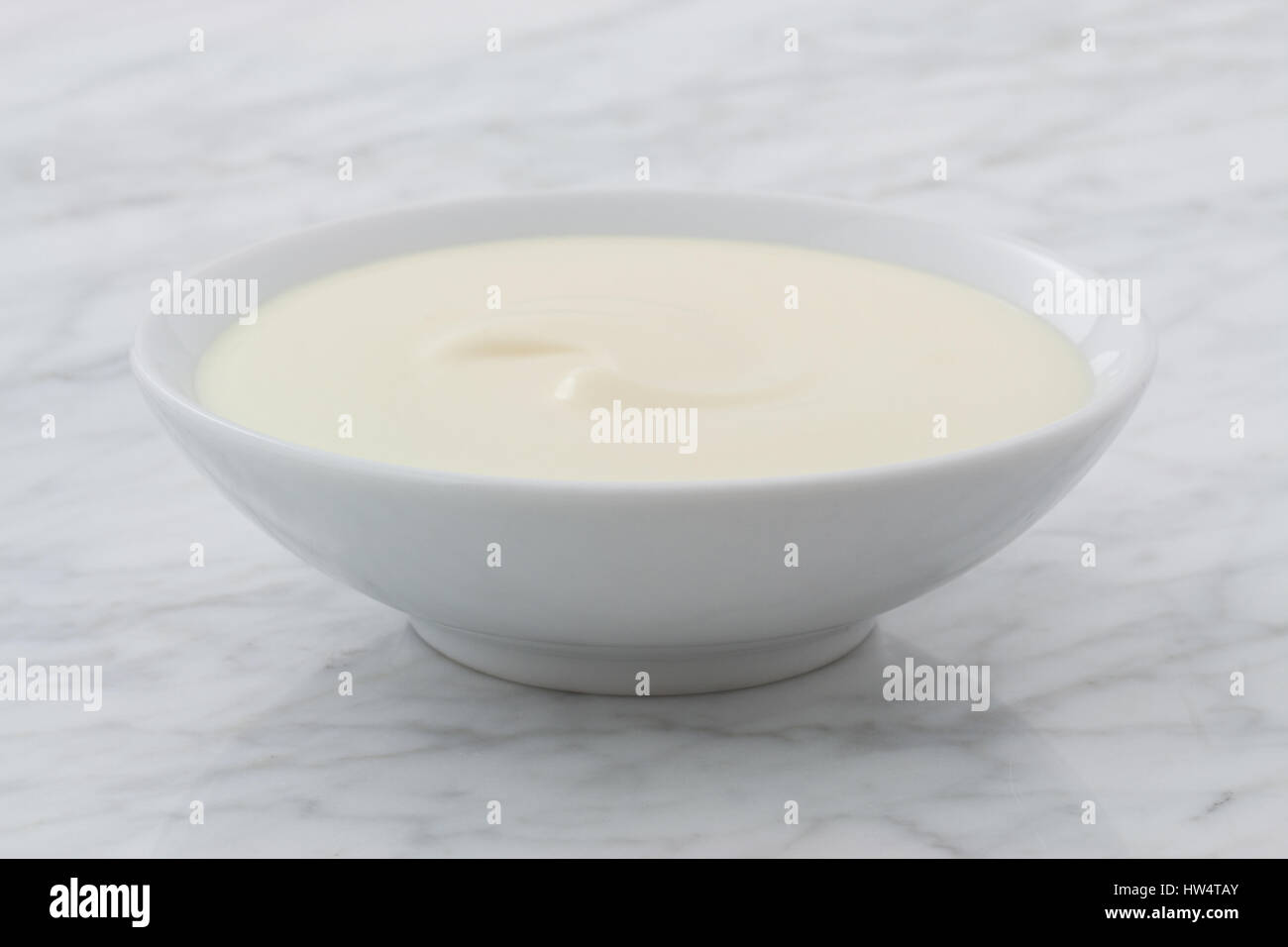 styled greek yogurt on carrara marble countertop Stock Photo